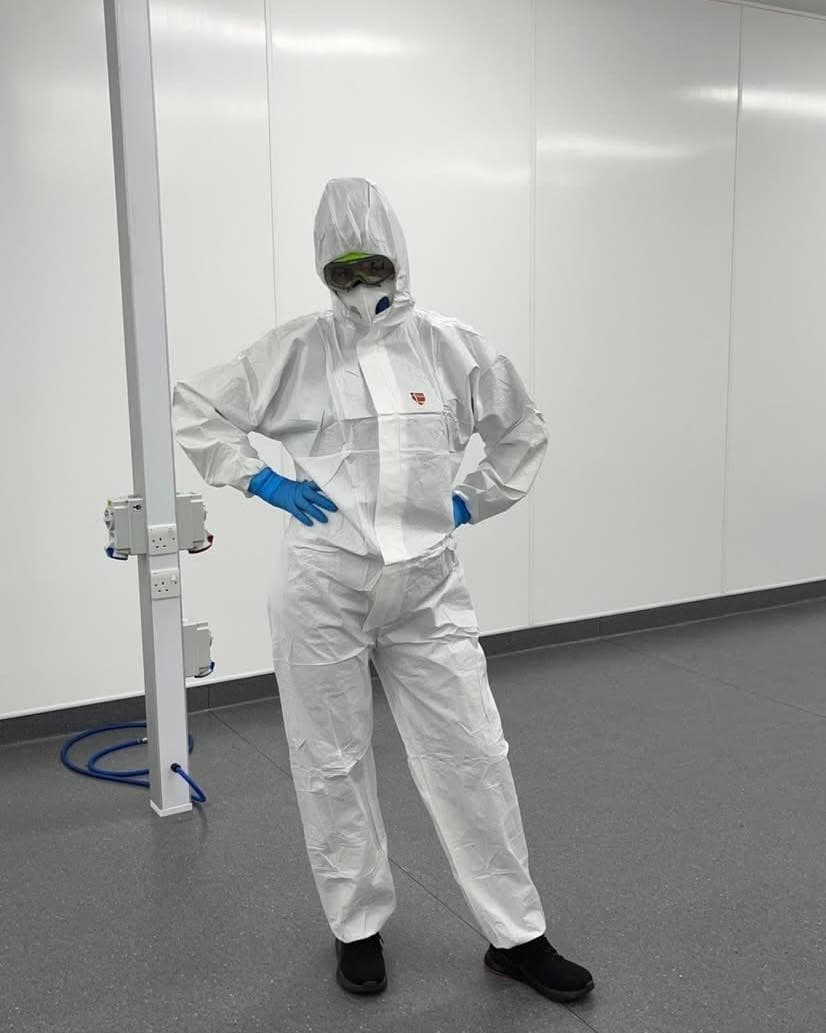 Tegan in a cleanroom suit from her decontamination technician background